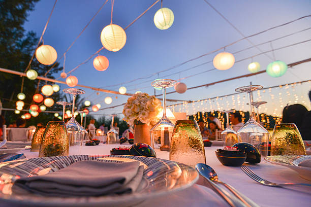 Elegant outdoor reception with rope lighting at sunset